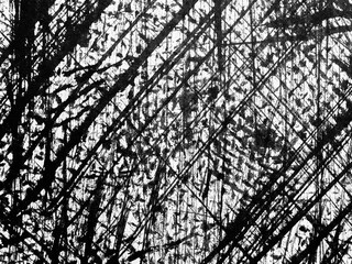 Abstract black and white artwork with intersecting lines and textures created using mixed media techniques in a studio setting