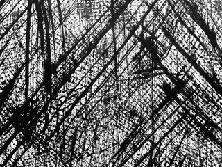 Abstract black and white texture with sharp diagonal lines created through dynamic brush strokes on a canvas surface