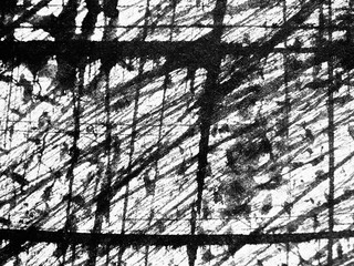 Abstract black and white patterns created by ink and texture on paper in a bright studio environment