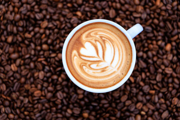 cappuccino white cup and roasted coffee beans backgrounds abstrack, top view