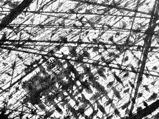 Abstract textures created by intersecting lines on a surface in black and white reflecting...