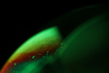 Green liquid surface, green on black, scientific background, macro view