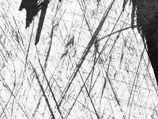 Intricate black and white abstract texture created by random scratches on a surface