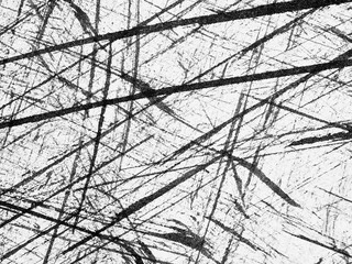 Abstract black and white lines create dynamic texture on a rough surface in a modern art setting
