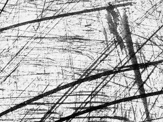 Abstract texture featuring intersecting lines and scratches on a white background created by...