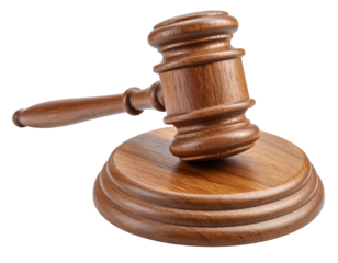 A wooden judge's gavel resting on a matching round sound block, symbolizing authority and legal decision-making.