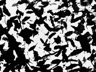 Abstract black and white pattern resembling textured brush strokes created through artistic...