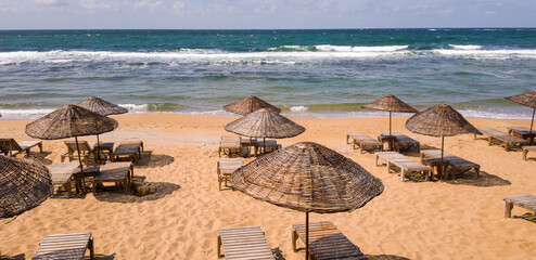 a sunny day, blue sea, beach and sun loungers
