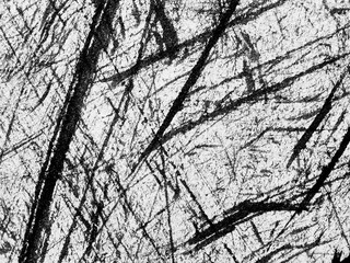 Abstract black and white textures showcasing intricate scratch patterns on a surface