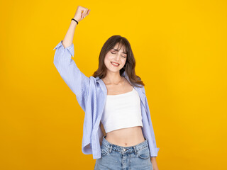 Celebrating woman, studio portrait of young caucasian brunette celebrating woman clenching fist say...