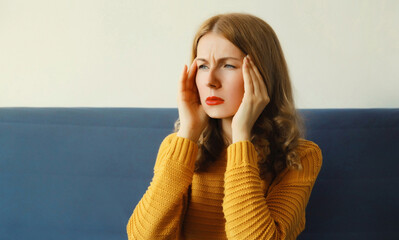 Exhausted tired woman suffering from headache, stress, fatigue, temples pain, migraine, loud noise