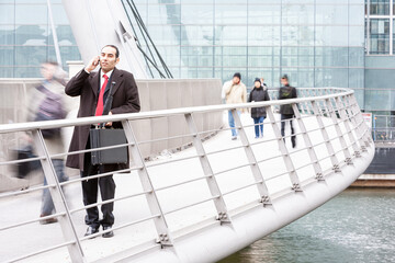 City Businessman, On Call. A London business professional candidly taking a phone call in his native urban environment. From an image series on the same subject.