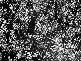 Abstract black and white texture with intricate patterns created by overlapping lines and shapes in a random arrangement