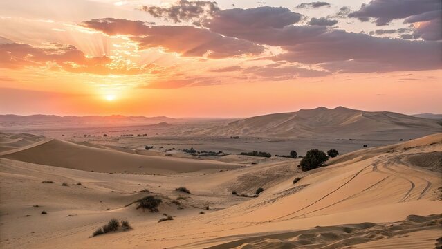 Desert landscape with sand dunes under a sunset sky featuring orange and pink hues with sun rays breaking through clouds