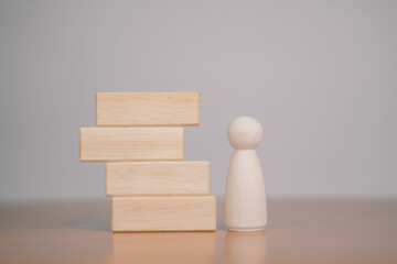 Several wooden blocks are placed on a table with a white background.	