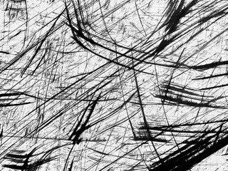 Abstract black and white patterns created by bold brush strokes on a textured surface