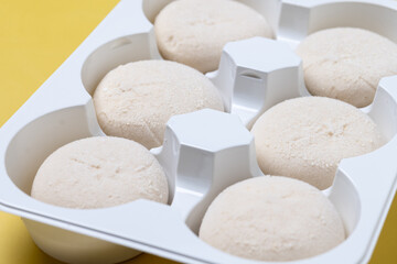 Japanese Cheesecake ice cream mochi on yellow background. Copy space