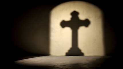 Silhouette of the crucifix against a wall illuminated by warm light, creating a peaceful, spiritual, and reflective atmosphere symbolizing faith and hope.
