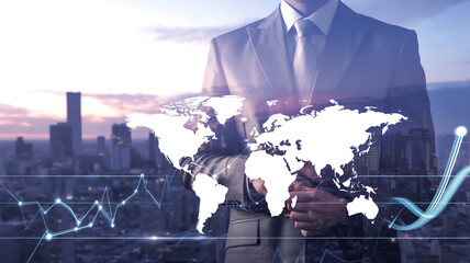 Businessman holding global map with financial charts