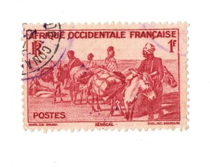 A vintage postage stamp from French West Africa isolated on a white background.