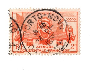 A vintage postage stamp from French West Africa isolated on a white background.