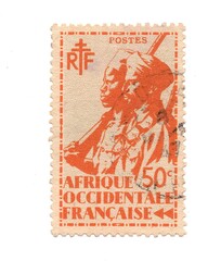 A vintage postage stamp from French West Africa isolated on a white background.