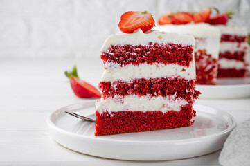 Red velvet cake with fresh strawberries. Festive layered cake from red sponge cakes and cream cheese frosting. American cuisine.