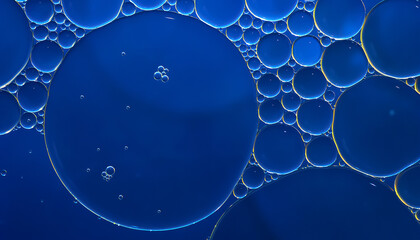 Oil bubbles. Close-up of oil bubbles on water. Abstract texture in dark blue tones. Macro...
