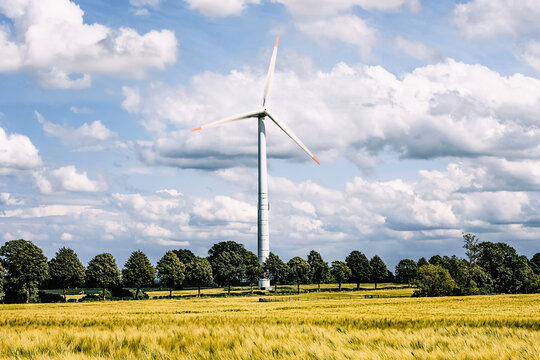 A wind turbine for generating electricity on a meadow in Germany.