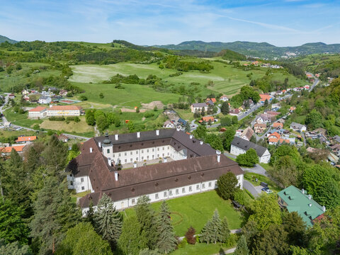Aerial view of the grand Sv&Atilde;&curren;t&Atilde;&frac12; Anton manor framed by lush greenery and a distant village, a blend of architectural heritage and natural beauty., Sv&Atilde;&curren;t&Atilde;&frac12; Anton, Bansk&Atilde;&iexcl; Bystrica Region, Slovakia.