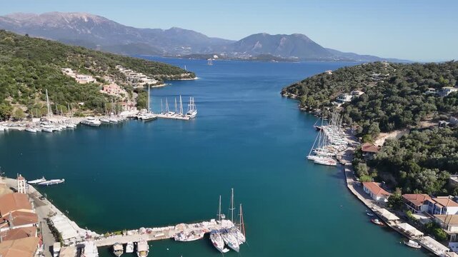 Low flyover of sailboats in turquoise Vathy Bay on west coast of Greece