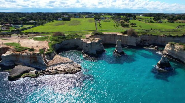Faraglioni di Sant'Andrea - Torre Sant'Andrea, Salento, Lecce, Apulia, Italy - side aerial shot with stunning view over the coastline