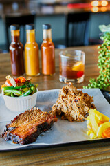 BBQ platter with pulled pork, brisket, and roasted vegetables