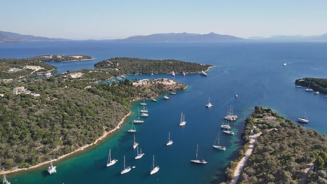 Low flight over small bay on coast of Greece with moored sailboats