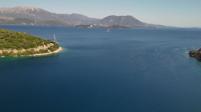 Ionian Sea aerial in Greece: two-masted ship motors between islands