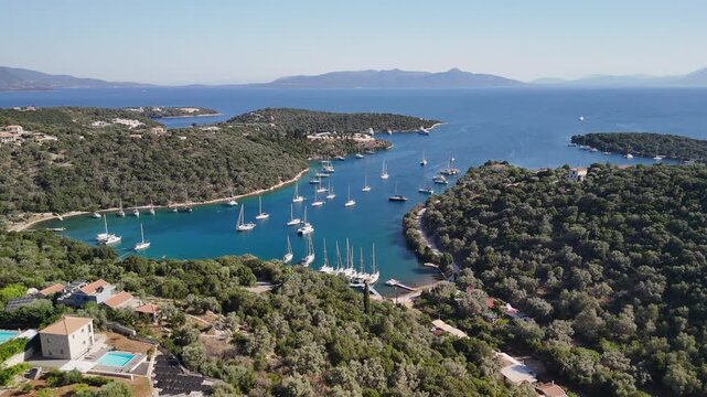 Flyover sailboats moored in quiet protected bay on Greek coastline