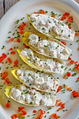 chicken salad endive lettuce cups topped with bell pepper and chives