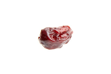 Close-up of a single dried cranberry with wrinkled texture and glossy surface, isolated on a clean...