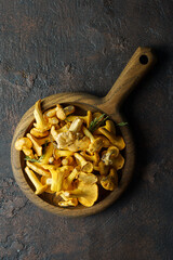 forest chanterelle mushrooms in wood plate