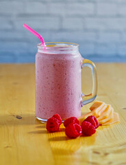 blended smoothie with fresh raspberries, cantaloupe, and yogurt