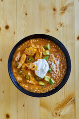 creamy chicken enchilada soup with avocado, jalapeno, and sour cream