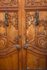 Intricately carved wooden doors showcasing craftsmanship in Toro, Zamora, Castilla y Leon at sunset