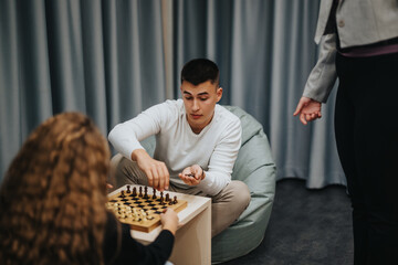 A group of high school students engage in a chess game, fostering strategic thinking and...