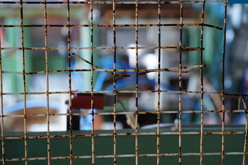Rusted Wire Mesh – Industrial Grid Texture with Blurred Background