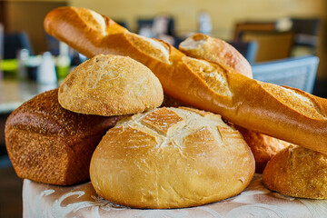 fresh baked bread including a baguette, sourdough loaf, Italian loaf, and hard rolls