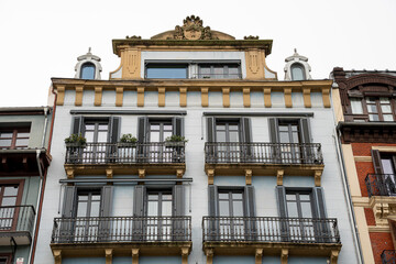 Historic architecture showcases elegant balconies in Pamplona, Navarra, Spain on a cloudy day