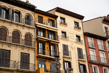 Colorful balconies of historic buildings in Pamplona, Navarra, showcasing Spanish architecture