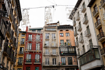 Festive decorations illuminate historic buildings in Pamplona Navarra during a vibrant celebration...