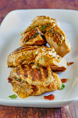 grilled pork chops stuffed with gouda cheese, bacon, spinach and sun dried tomatoes, front piece not sliced