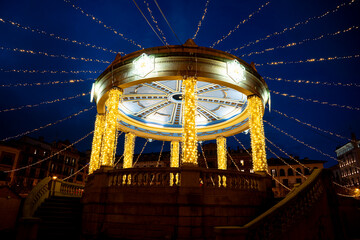 Stunning illuminated gazebo in Plaza del Castillo during evening hours in Pamplona, Navarra, Spain